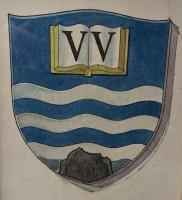 A blue shield with three white wavy lines, a black rock at the bottom, and an open book with "VV" on its pages at the top.
