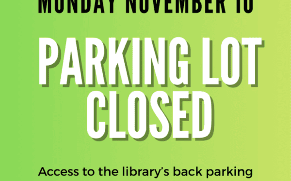 Sign announcing that the library’s parking lot will be closed on Monday, November 18, and access to the back parking will be unavailable.